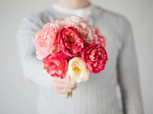 persona che regala mazzo di fiori