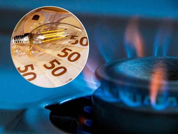 sfondo fornello del gas, in primo piano banconote e lampadina