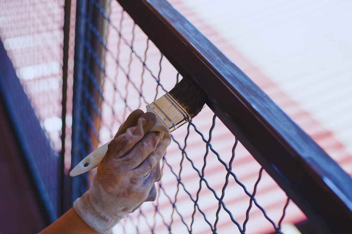 Persona che vernicia ringhiera