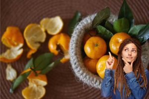 Ragazza che riflette e bucce di mandarino