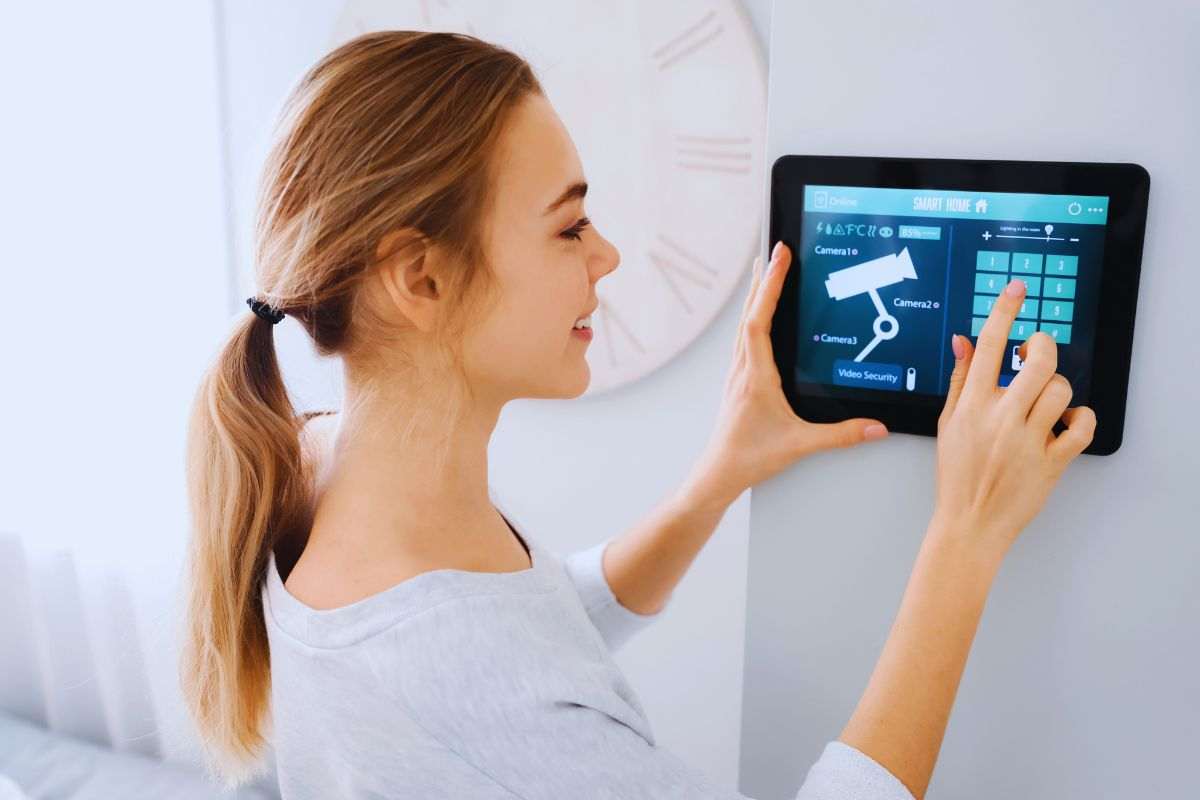 Donna che imposta il sistema d'allarme da un tablet
