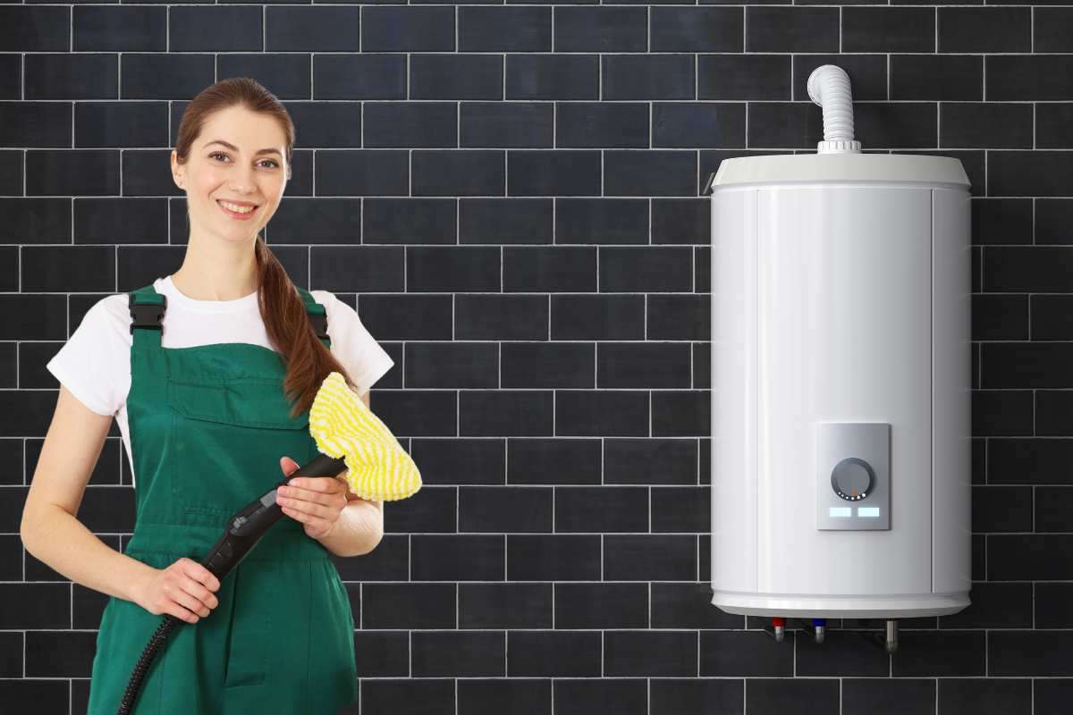 Donna si prepara a pulire lo scaldabagno