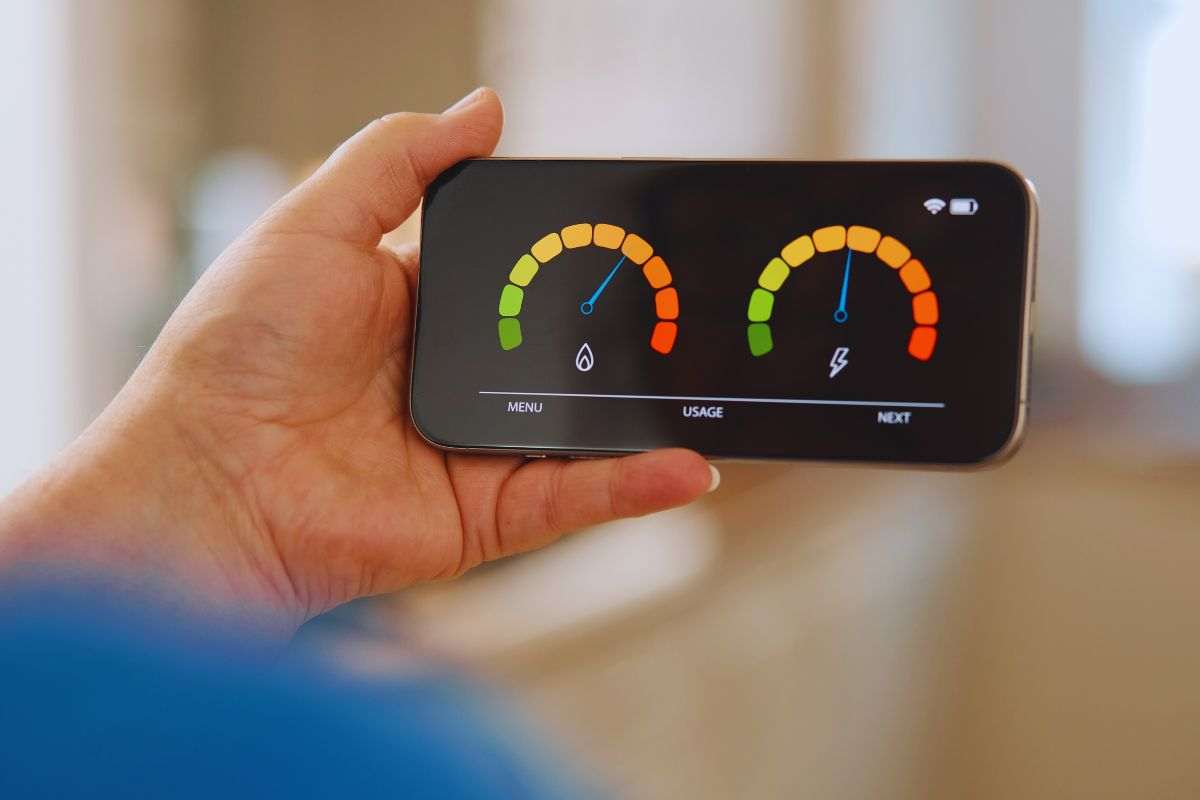 Persona che controlla i consumi energetici tramite app smartphone